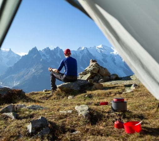 Un homme fait du bivouac en montagne